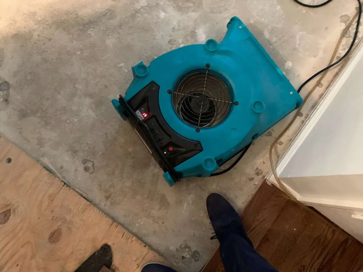 Air mover drying subfloor during Commercial Water Damage Restoration in West Chicago